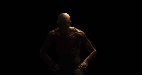 Distressed figure in dark room depicting fear and suffering