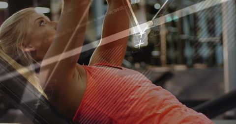 Woman Performing Dumbbell Shoulder Press in Gym with Data Overlay
