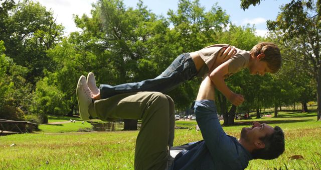 Father playing with son in park outdoors on sunny day - Download Free Stock Images Pikwizard.com