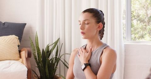 Wellness and Mindfulness Practice at Home by Calm Mid Adult Woman