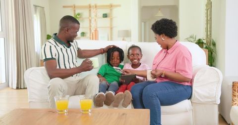 Happy Family Celebrating Announcement on Cozy Home Couch