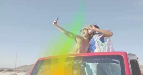 Joyful Women Taking Selfie From Convertible Sunroof
