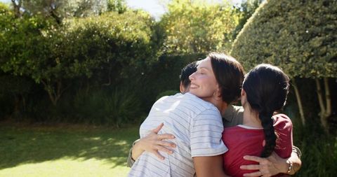 Joyful Family Embrace in Sunlit Garden
