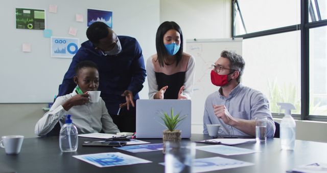 Diverse team collaborating during office meeting while wearing masks - Download Free Stock Images Pikwizard.com