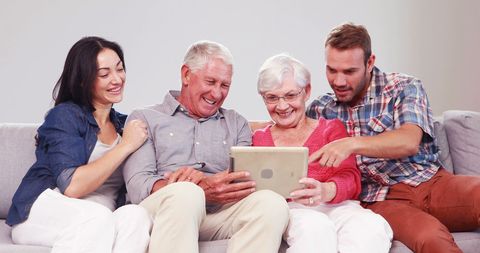 Multigenerational Family Using Tablet on Cozy Couch - Download Free Stock Images Pikwizard.com