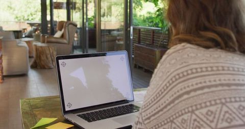 Pregnant Woman Working from Home with Laptop in Cozy Environment