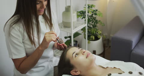 Woman Relaxing During Professional Eyebrow Tinting Session at Salon