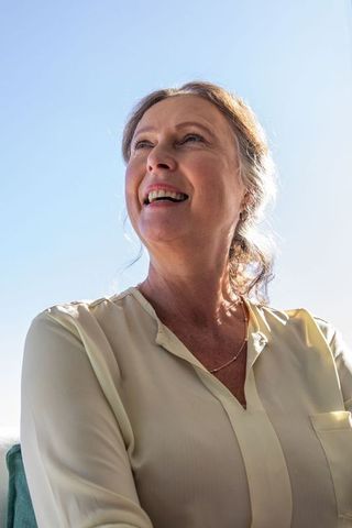 Senior Woman Enjoying Sunshine and Fresh Air in Elegant Attire