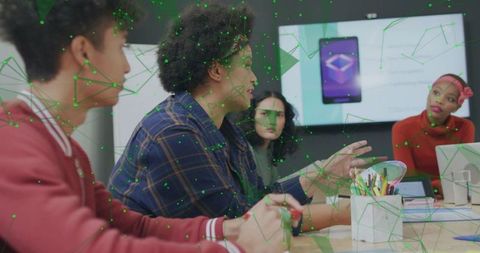 Team collaborating around table with woman presenting app on screen in modern meeting room