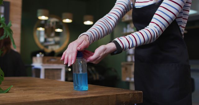 Barber sanitizing hands with sanitizer in modern barbershop - Download Free Stock Images Pikwizard.com