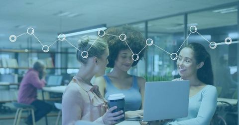 Female team collaboration in modern office with technology overlay