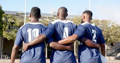 Soccer Players Embracing Team Spirit on Field