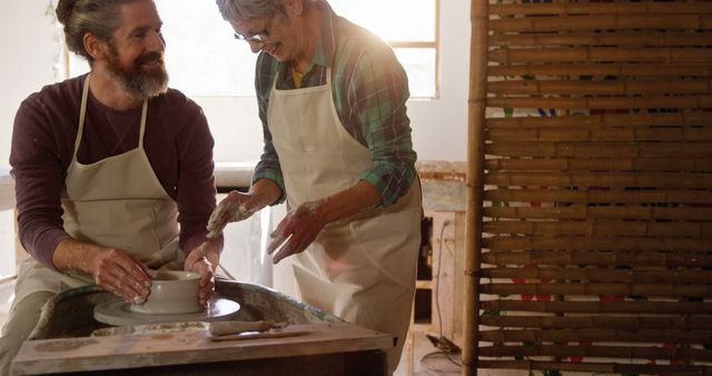 Smiling Artisans Creating Pottery in Workshop - Download Free Stock Images Pikwizard.com