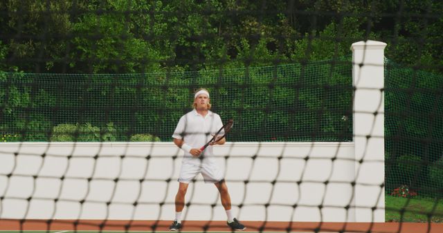 Senior Male Player Preparing to Serve on Tennis Court - Download Free Stock Images Pikwizard.com