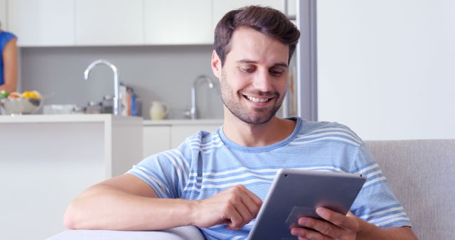 Smiling Man Using Digital Tablet in Modern Home - Download Free Stock Images Pikwizard.com