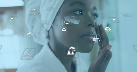 Woman using eye cream with futuristic ar interface in bathroom