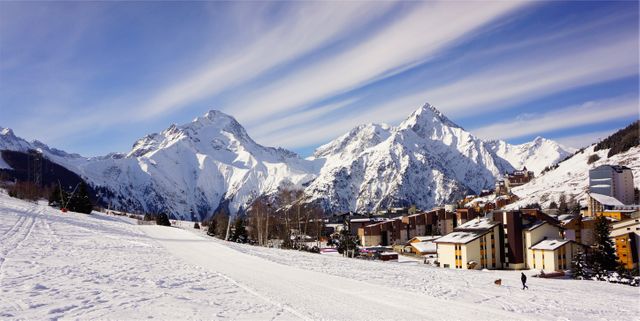 Breathtaking Snowy Mountain Range with Winter Resort Town - Download Free Stock Photos Pikwizard.com