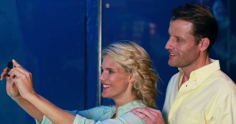 Middle-Aged Couple Enjoying Leisurely Date at Aquarium