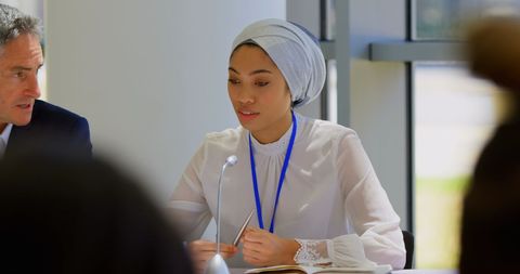Diverse Business Professionals Discussing in Seminar Meeting Room
