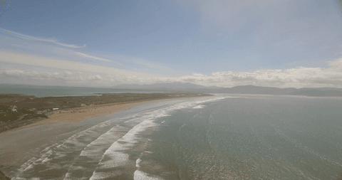 transparent ocean waves against vast coastal horizon - Download Free Stock Videos Pikwizard.com