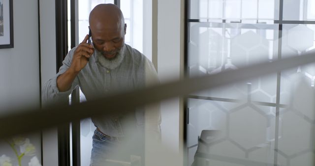 Mature Professional Talking on Phone in Modern Office - Download Free Stock Images Pikwizard.com