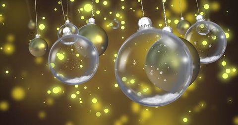 Glass Baubles Hanging with Snowflakes on Yellow Background