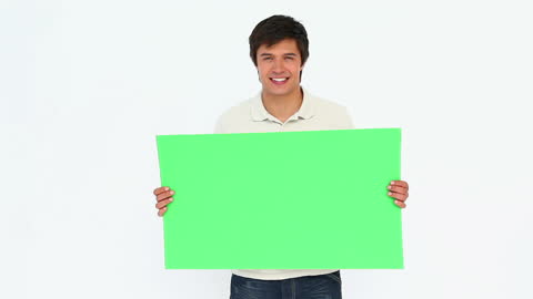 Smiling Man Holding Blank Green Sign for Copy Space