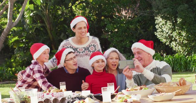 Happy caucasian family having christmas dinner in garden. Spending quality time with family at home concept.