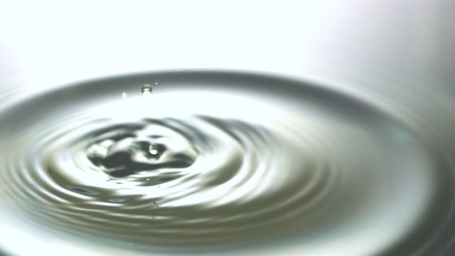 This serene depiction of water surface with ripples and droplets captured in slow motion brings a sense of calm and fluidity. It is perfect for use in projects related to science, nature, meditation, relaxation, and advertising purity and freshness. Suitable for illustrating concepts of water conservation, environmental awareness, and fluid motion studies.