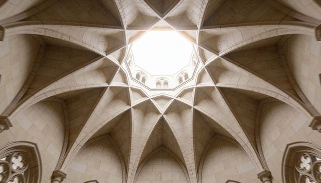 Radiating gothic ribbed vault ceiling featuring star-shaped oculus in stone chapel