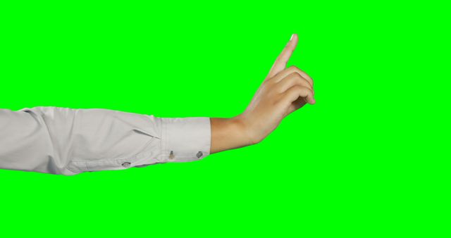 Human hand wearing white shirt sleeve pointing upwards with index finger against green screen background. Ideal for graphic design, video editing, gesture illustration and conveying direction or instructions. Can be used for educational content, promotional materials and user interface design.