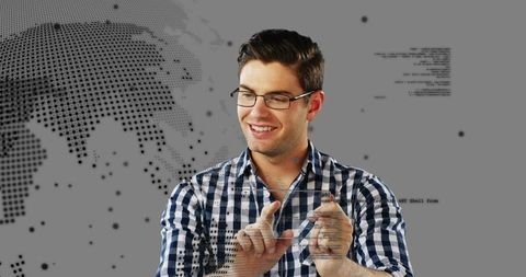 Young man interacting with holographic world map interface using stylus and gestures