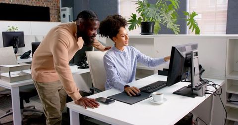 Business Colleagues Collaborating on Digital Project in Modern Office