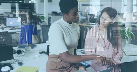 Coworkers Collaborating Over Tablet With Data Dashboards Reviewing Analytics in Open-Plan Office