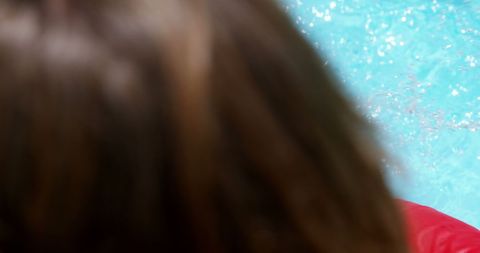 Blurred Hair of Woman in Sunlit Garden Pool