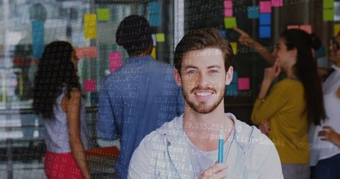 Young developer presenting idea at glass wall with sticky notes and code overlay