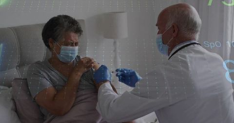 Senior Patient Receiving Vaccine from Doctor in Home Care Setting