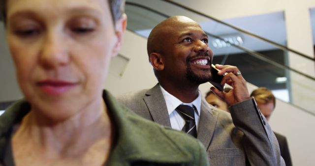 Confident Businessman on Phone in Busy Office - Download Free Stock Images Pikwizard.com