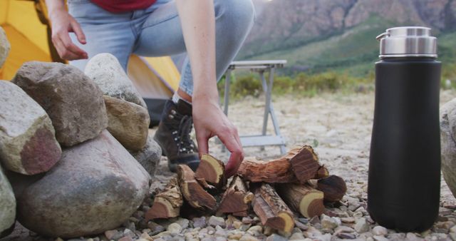 Person Preparing Campfire Outdoors Near Tent - Download Free Stock Images Pikwizard.com