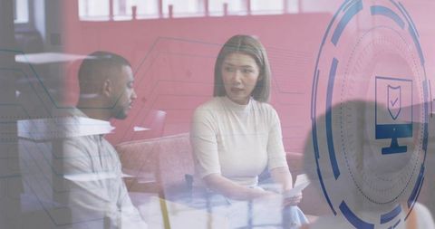 Colleagues Discussing Cybersecurity Briefing in Modern Office Lounge with Digital Overlay