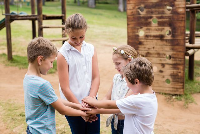 Children Forming Hand Stack in Park on Sunny Day - Download Free Stock Photos Pikwizard.com