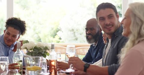 Friends Enjoying Drinks and Conversation at Festive Reception