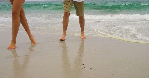Couple Strolling on Beach, Enjoying Ocean Waves - Download Free Stock Images Pikwizard.com