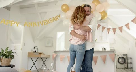 Joyful anniversary celebration at home with loving couple