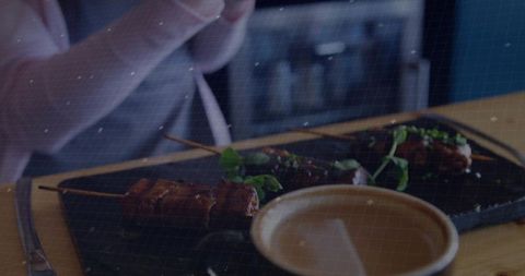 Gourmet presentation of grilled meat skewers with coffee