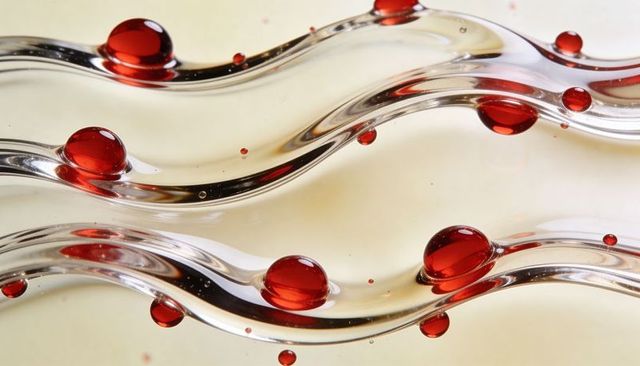 Red droplets on wavy transparent tubes abstract crystal spheres and bubbles cream backdrop