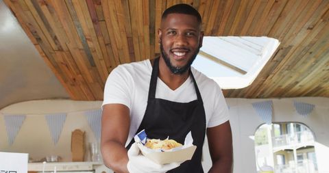 Smiling Food Truck Chef Serving Delicious Street Food - Download Free Stock Images Pikwizard.com