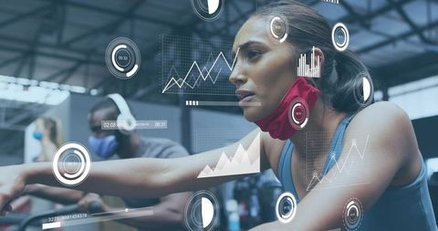 Female cyclist training with real-time performance metrics and ar overlays in gym