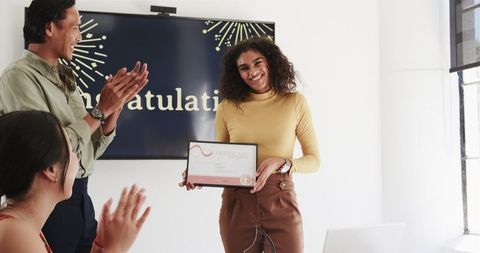 Diverse Team Celebrating Achievement in Office Setting