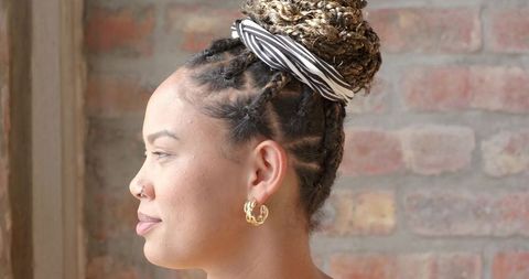 Fashionable Modern Woman with Braided Bun and Patterned Scarf